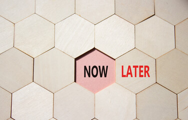 Now vs Later symbol. Concept word Now vs Later on wooden comb puzzle. Beautiful pink background....