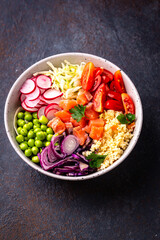Balanced healthy bowl with vegetables and salmon