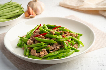 Stir Fried french green beans and Minced Pork with oyster sauce in white plate
