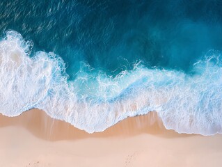 Minimalist Aerial View of a Blue Ocean Wave Breaking on a Sandy Beach