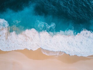 Minimalist Aerial View of a Blue Ocean Wave Breaking on a Sandy Beach