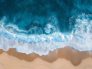 Minimalist Aerial View of a Blue Ocean Wave Breaking on a Sandy Beach