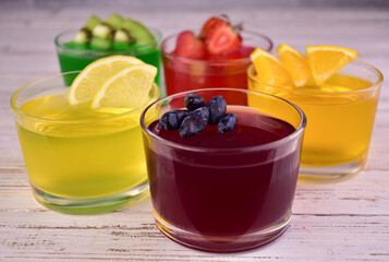 Various jellies in glasses. Assorted cool jelly desserts.	