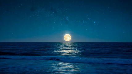 A serene nighttime seascape photograph with a full moon rising over dark blue waters.