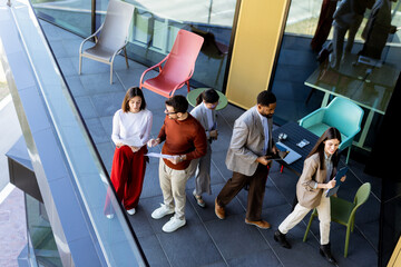 Team brainstorming and collaboration on a terrace during a sunny afternoon in a modern setting