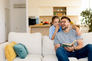 Joyful moments of laughter and storytelling between a father and daughter in a cozy living room