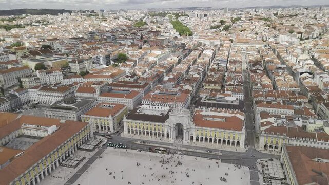 Drone flies north over Pra&ccedil;a do Comercio toward the Elevador de Santa Justa in Lisbon, Portugal