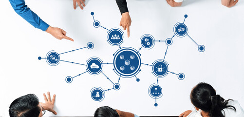 Dynamic business strategy session depicting a collaborative environment where diverse team members engage with visual connections on a table full of innovative ideas. Amity