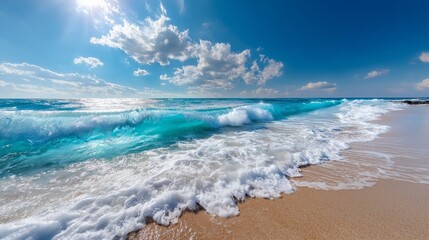 Top view of ocean waves washing onto sandy beach