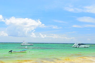 El Cortecito, Punta Cana, Dominican Republic- June 12, 2025: People walking along the coastline and sunbathing on one of the best beach in Caribbean area. Lots  of seaweed, specifically Sargassum.