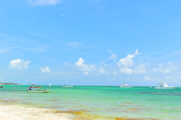 El Cortecito, Punta Cana, Dominican Republic- June 12, 2025: People walking along the coastline and sunbathing on one of the best beach in Caribbean area. Lots  of seaweed, specifically Sargassum.