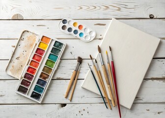 Flatlay of Paintbrushes Palette and Canvas on Rustic White Wooden Table