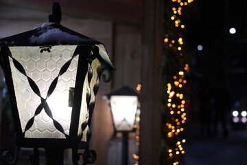 Glowing street lights and festive garlands.