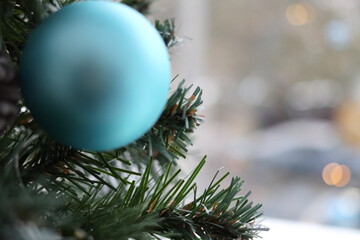 Fir branch with balls and festive lights.
