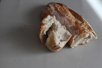 A broken freshly baked rustic baguette.