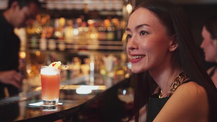 Friends or couple talking in focusing Paloma cocktail at luxurious counter bar, celebrating special party beverage in Margarita and Old fashioned at vibrant nightclub lifestyle Friday night. Vinosity.