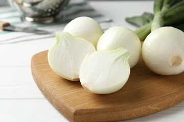Fresh ripe green onions on white wooden table, closeup