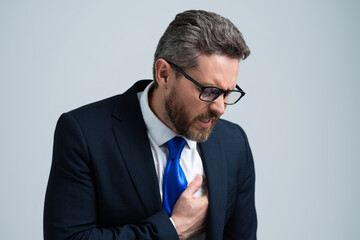 Stressed business man in suit having headache. Tired businessman is working overtime and has...