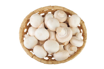 Fresh mushroom champignon in a wicker basket isolated on white background. Top view. Flat lay