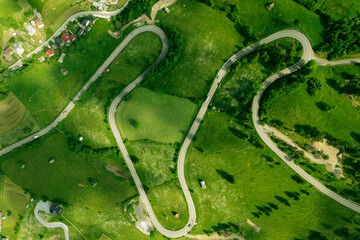 Top view or aerial of the road passing through the mountain and green forest.Curve asphalt road on mountain forest summer.