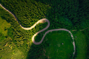 Top view or aerial of the road passing through the mountain and green forest.Curve asphalt road on mountain forest summer.