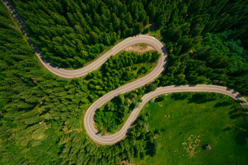 Top view or aerial of the road passing through the mountain and green forest.Curve asphalt road on mountain forest summer.