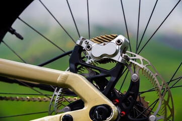 Close-up of mountain bike brake disc part. Technical expertise of bike shop service in the open air. Mountain bike parts