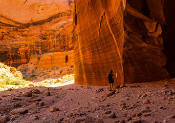 Female Hiker With Large Sandstone Alcove at The Confluence of Wire Pass and Buckskin Gulch, Vermillion Cliffs National Monument, Utah, USA
