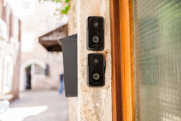 Smart doorbells on old stone entryway. Urban security, smart technology, and modern living in traditional architectural settings. Copy space.