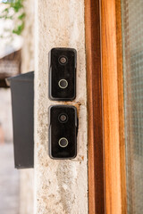 Smart doorbells on old stone entryway. Urban security, smart technology, and modern living in traditional architectural settings.