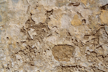 Old wall with peeling plaster or stucco for use as a background texture