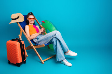 Young woman in casual attire enjoying summer vacation with travel props and a cheerful background...