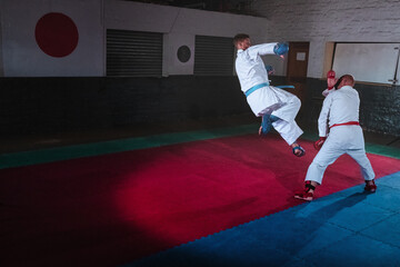 Teenage Boy Practicing Karate with His Father and Instructor