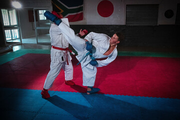 Teenage Boy Practicing Karate with His Father and Instructor