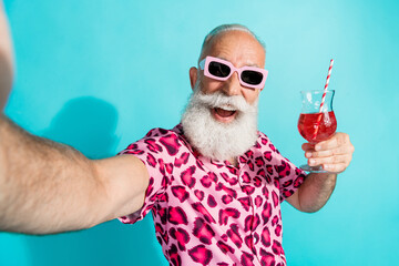 Portrait of funky aged man take selfie cocktail wear leopard print costume isolated on turquoise...
