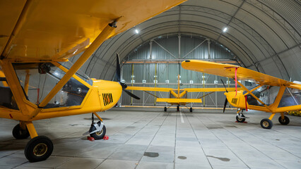 Yellow airplane glider in the hangar. 