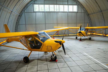 Yellow airplane glider in the hangar. 