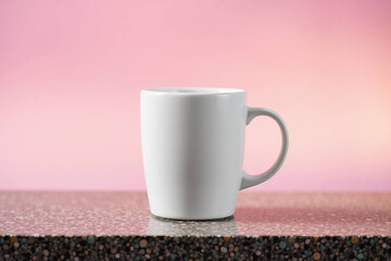 Obraz premium White Ceramic Mug on Soft Pink Background - Minimalist Style