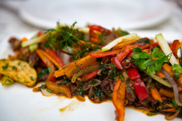 Roast with vegetables very tasty on a white plate