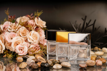 Sophisticated product photography featuring perfume bottles, flowers, and smooth stones.