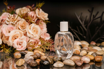 Stylish perfume bottles surrounded by roses and pebbles, ideal for romantic product shots.