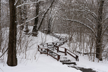 Wooden staircase with snow in winter.