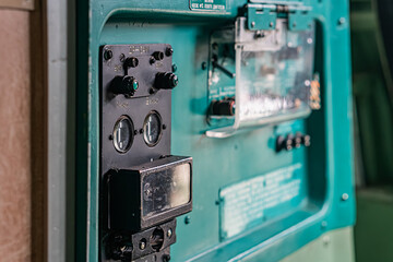 Image of an airplane cabin interior featuring an industrial control panel with dials, switches, and...