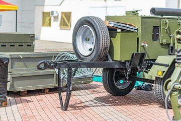 An outdoor image featuring a military armored personnel carrier APC without windows or doors,...