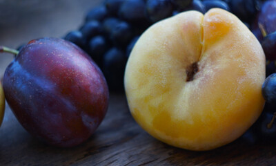 Black grapes, yellow leaves, various fruits on a blackboard