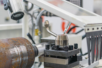 Close-up view of a metallic mechanical component, possibly part of a conveyor system or similar...