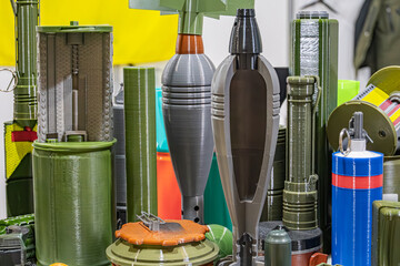Image of explosive mining equipment in various sizes and shapes, predominantly green, yellow, and...