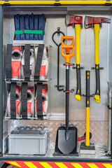 Image of a firefighters toolbox, displaying organized equipment Contains yellow pliers, red...