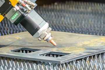 Close-up of an industrial scene featuring a robotic arm attaching a metallic structure with cooling...
