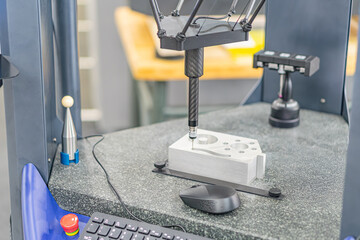Close-up of an active CNC milling machine in a high-tech industrial workspace The machine, painted...